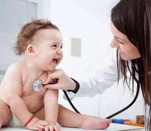 Doctor using stethoscope on a baby