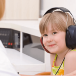 child receiving audiology test from audiologist
