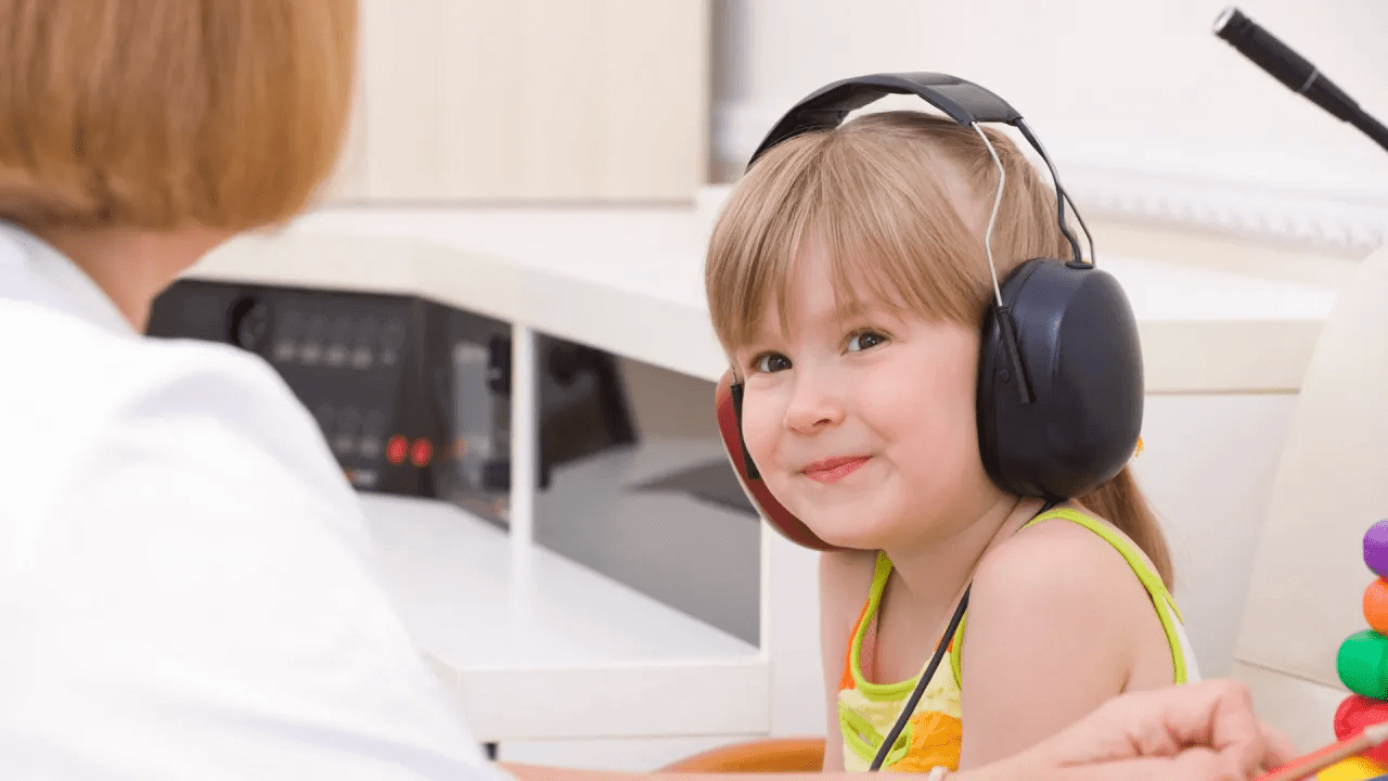 child receiving audiology test from audiologist